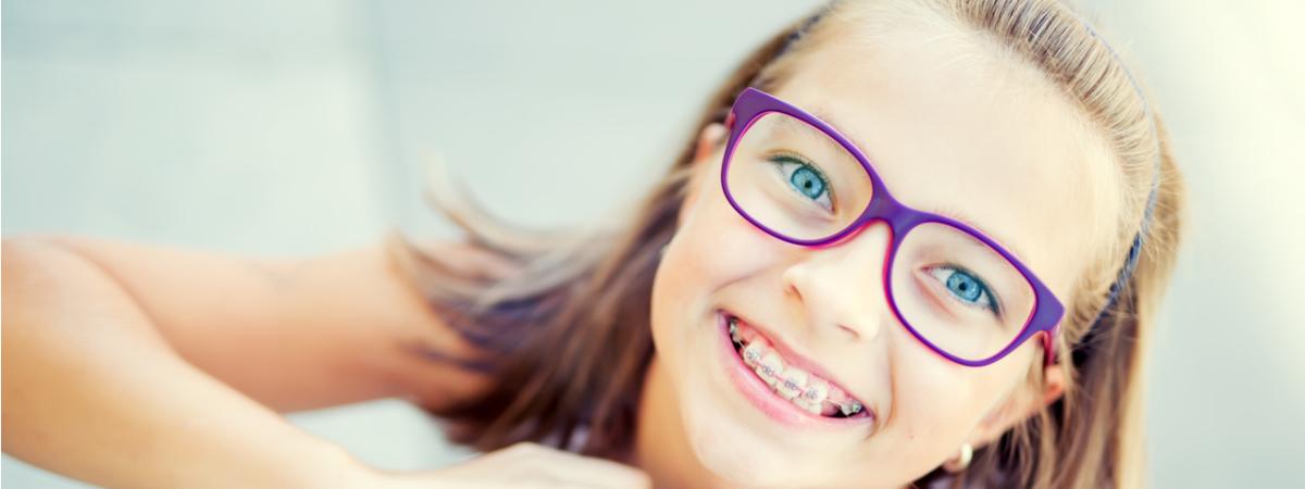 Young child with braces and glasses