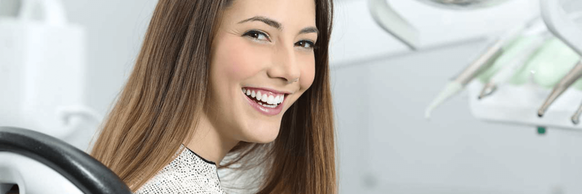 Smiling Teenage girl sitting in dentist chair